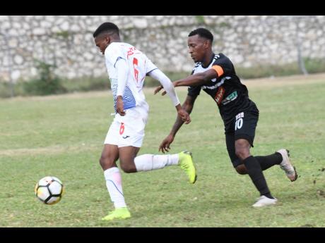 Cavalier’s Chevone Marsh (right) challenges Portmore United’s Lamar Walker for the ball during a Red Stripe Premier League match on February 10, 2019.