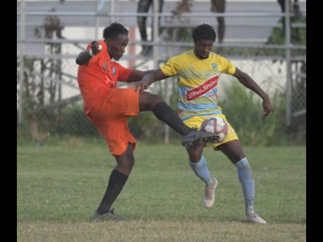 Tivoli Gardens’ Jabeur Johnson (left) tackles Waterhouse player Colorado Murray in their Red Stripe Premier League encounter at the Edward Seaga Sports Complex on December 19, 2019.