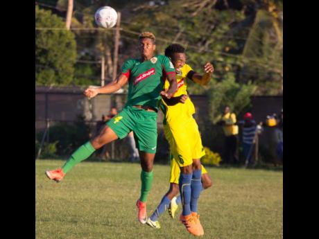Humble Lion’s Andre Clennon (left) jumps high for a ball with Vere United’s Kenroy Lumsden during their recent Red Stripe Premier League match on December 15, 2019.