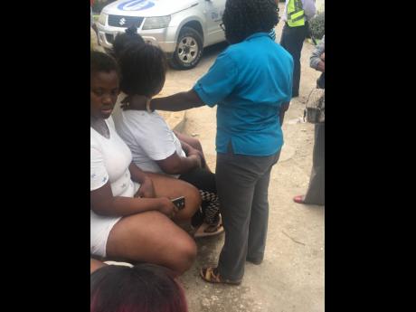 Charmaine Henry (centre) being comforted.