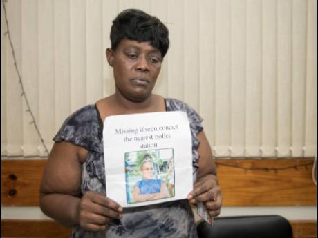 Georgia Woods holds the flyer with the photo of her missing granddaughter, Ackeela Jones.