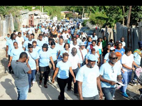 August Town residents march while celebrating peace in their community in 2017.