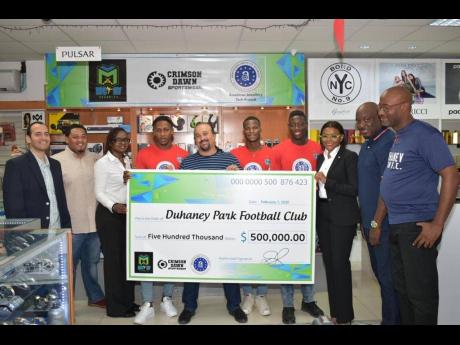 From left:  Raj Khemlani, director, American Jewellery Company Tech Branch; Todd Rhoden, Crimson Dawn; Donna Roache, executive location manager, McKay Security; player Kemar Reid; sponsor Jason McKay, chief executive officer, McKay Security; players Odare Wilson and Shaquan Davis, are joined by Jacqueline Domenico, vice-president, marketing and client services, McKay Security; as well as coach Clareton Walker and manager Darrington Ferguson of Duhaney Park Football Club. 