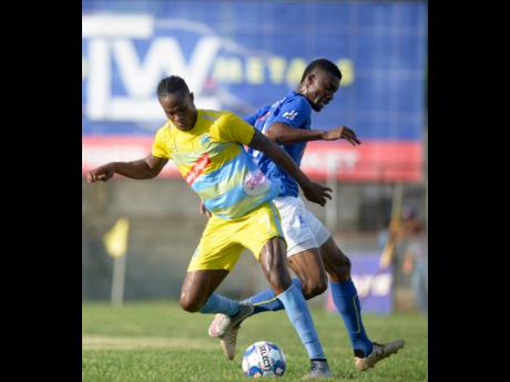 Waterhouse’s Stephen Williams shields the ball from Anjay Gayle of Vere United during their Red Stripe Premier League encounter at Drewsland on September 12, 2019.
