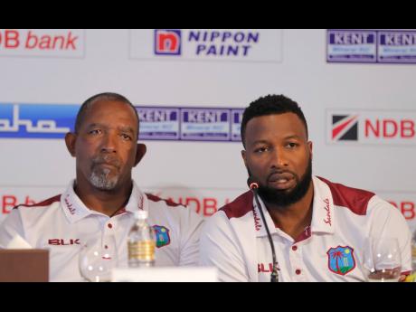 West Indies’ cricket captain Kieron Pollard (right) speaks to media as coach Phil Simmons looks on during the inauguration of NDB series trophy in Colombo, Sri Lanka, on Wednesday. 