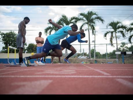 Jamaica College’s sprinters Jonathan Henry (foreground) and Christopher Scott launch out of the starting block during a training session at the Ashenhiem Stadium on their school compound as they prepare for the 2020 ISSA/GraceKennedy Boys and Girls’ Athletics Championships.