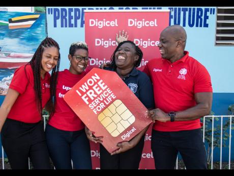 It was a super happy moment for Digicel customer, Andrene Holness (second right), when she officially received her “Free Mobile Service for Life” prize from Digicel Public Relations and Communications Manager, Elon Parkinson (right), Brand Marketing Manager, Michaela Francis (second left), and Digital Media Executive, Kadeen Brown. 