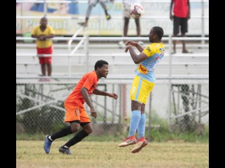 Waterhouse FC’s Nicoli Finlayson (right) heads the ball over Tivoli Gardens FC’s Stephen Barnett during their Red Stripe Premier League match at the Edward Seaga Sports Complex yesterday.
