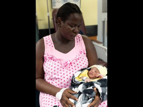 Credit: Gladstone Taylor Loretta Dunn holds her daughter, Princess Lawrence, who was born on February 29.