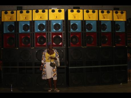 This patron stands in front of the imposing sound boxes.