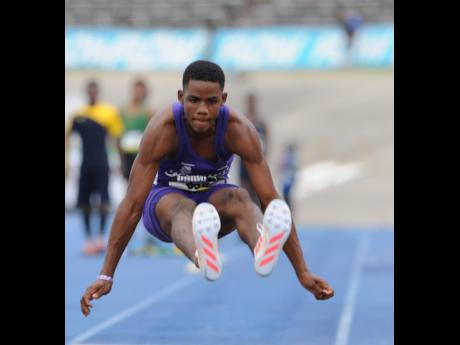 Kingston College’s Shaquille Lowe produces a big jump as he wins the Class Two Long Jump final at the 2017 ISSA/GraceKennedy Boys and Girls’ Athletics Championships.