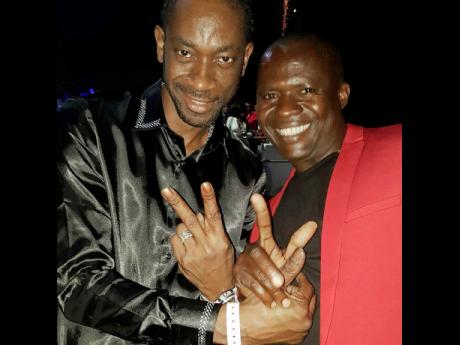 Dancehall entertainer Bounty Killer (left) shares 
a frame with producer and 
label owner 
Q45.