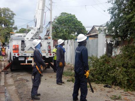 Credit: Akera Davis JPS workers were seen carrying out routine activities in Jones Town, Kingston, on Monday.
