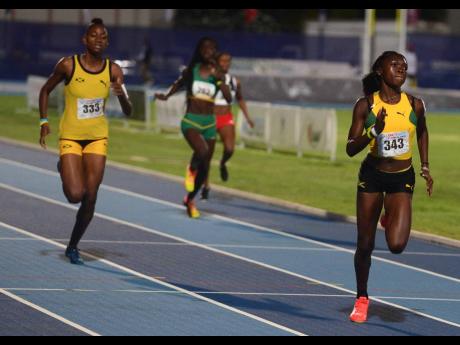 Jamaica’s Shaquena Foote (left) speeds to victory in the Under-20 Girls 400m hurdles at the Carifta Games in the Cayman Islands on April 21, 2019.
