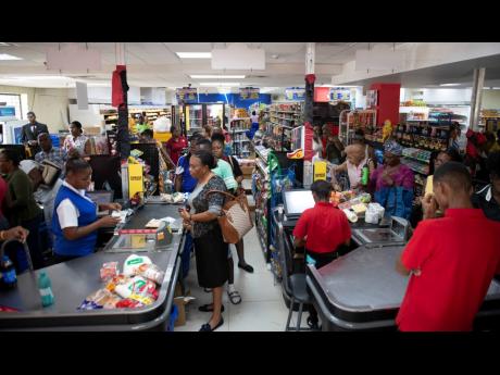 Members of the public shopping for supplies at the Hi-Lo Supermarket located on Old Hope Road in St Andrew last Friday.