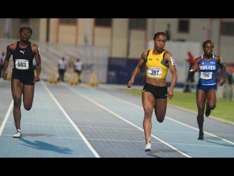Jamaica’s Briana Williams (centre) storms to victory in the Under 20 Girls 100m final at the 48th staging of the Carifta Games at the Truman Bodden Sports Complex in George Town, Cayman Islands on April 21, 2019.