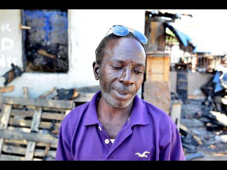Credit: Kenyon Hemans Lester Davis speaking with reporters after fire destroyed his workshop.