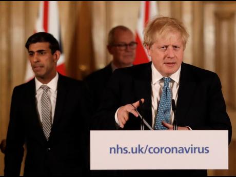 Britain’s Chancellor Rishi Sunak, British Prime Minister Boris Johnson, and Chief Scientific Officer Patrick Vallance arrive for a press briefing on the ongoing situation with the COVID-19 coronavirus outbreak, at 10 Downing Street in London, yesterday.