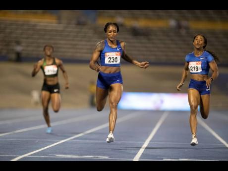 Elaine Thompson (centre) runs a world leading 22.00 seconds to win the women’s 200m finals at the JAAA National Senior Championship on June 23, 2019.