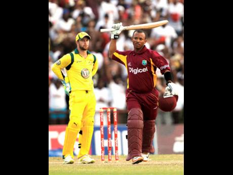 West Indies’ Carlton Baugh celebrates after scoring the winning runs as Australia wicketkeeper Matthew Wade looks on during their second one day international cricket match in Kingstown, St Vincent, Sunday, March 18, 2012. West Indies won by five wickets with 10 balls remaining under the Duckworth/Lewis method. 