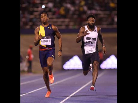 Akeem Bloomfield (left) moves away from Rasheed Dwyer to win the men’s 200m sprint in 20.34 seconds at the Racers Grand Prix at the National Stadium on Saturday, June 8, 2019.