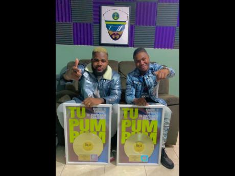 Record producer Trackstarr  (left) and artiste Sekuence show off their gold plaques earned for ‘Tu Pum Pum’ selling more than 500,000 copies.