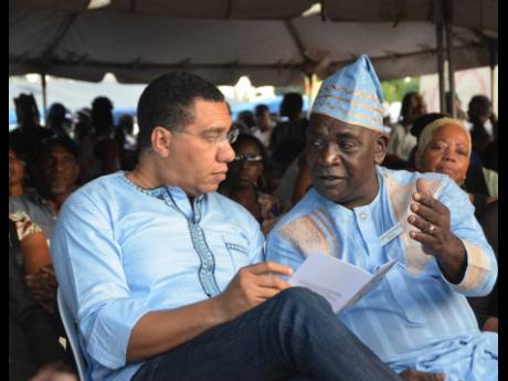 Credit: File Colonel of the Accompong Town Maroons Fearon Williams (right) has the ear of Prime Minister Andrew Holness.