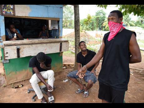 Credit: Ian Allen Young men in Time and Patience, a community near Linstead in St Catherine, say they are prepared to endure the lockdown in order to see the back of COVID-19.