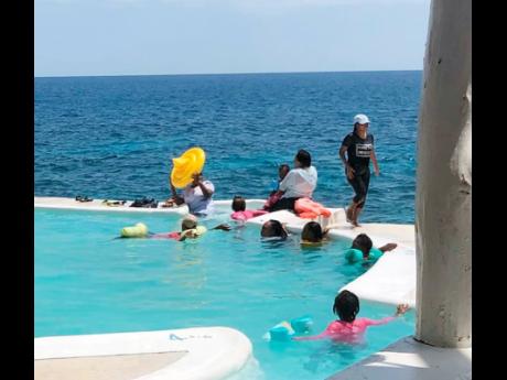 Credit: Contributed Some of the persons who invaded a private property in Negril.