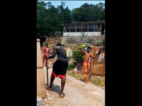 Credit: Contributed Residents of 8 Miles in St Ann build their barrier.