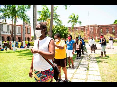 Persons wait in line to get packages.