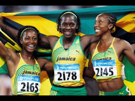 Jamaica’s gold
medallist Shelly-Ann Fraser (left) and silver medal winners Kerron Stewart (centre) and Sherone Simpson celebrate after the women’s 100-metre final at the 2008 Beijing Olympic Games.