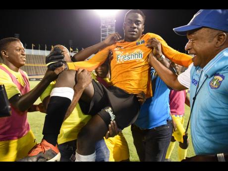 File
Prince Daniel Smith (centre), goalkeeper of Clarendon College, is carried off the field by teammates and supporters after they defeated Jamaica College on penalties to win the Olivier Shield title for 2019.