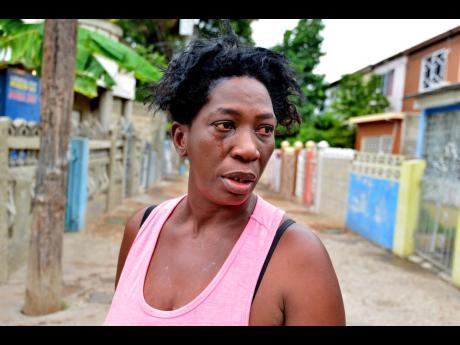 Marjorie Hinds cries as she remembers the events in Tivoli Gardens which left her spouse dead and her right arm crippled.