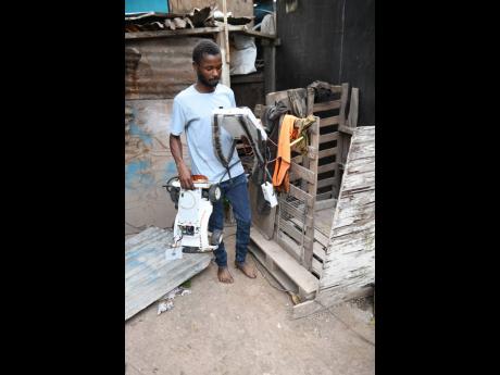 Dwayne Henry with some of the gadgets he made from scraps gathered at the Riverton City Dump.