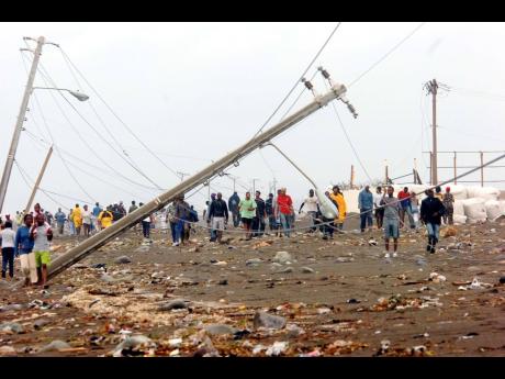 Hurricane Dean left its mark on the country in 2007. Here, people make their way to the Palisadoes in Kingston to view the devastation.