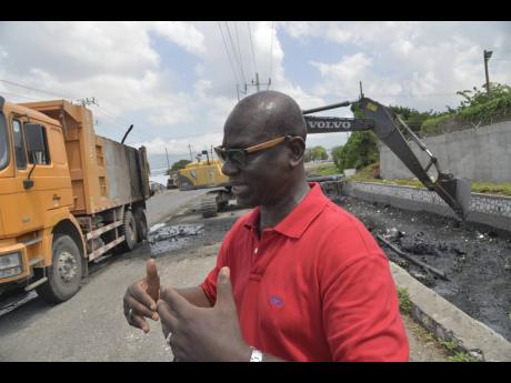 In this 2016 photo, Local Government Minister Desmond McKenzie oversees the cleaning of of a gully along Industrial Terrace in Kingston, in preparation for for Hurricane Matthew.