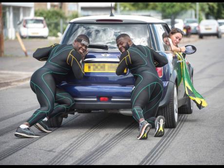 Jamaica bobsledders Nimroy Turgott (left) and Shawayne Stephens (right) push a car around Peterborough in the United Kingdom as they try to stay fit during coronavirus lockdown.