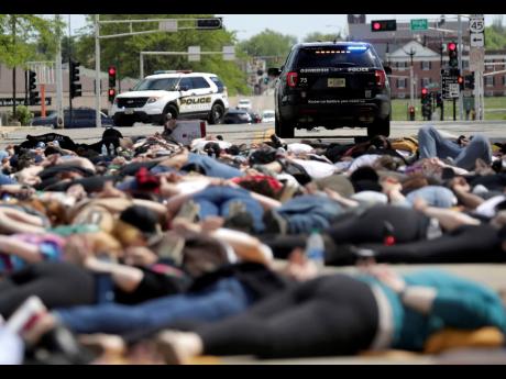 Protesters lie on the ground during a Black Lives Matter rally in Oshkosh, Wisconsin, yesterday. 