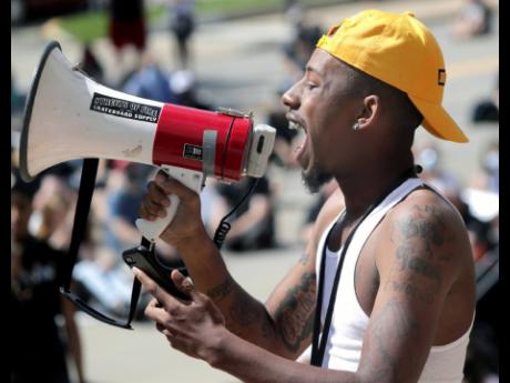 Ray Wright, Milwaukee, Wisconsin, speaks to protesters during a Black Lives Matter march and rally yesterday.