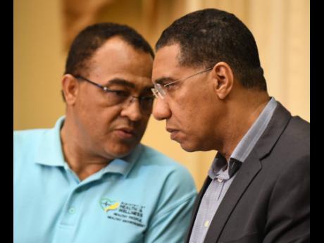 Health and Wellness Minister Dr Christopher Tufton (left)  and  Prime Minister Andrew Holness.