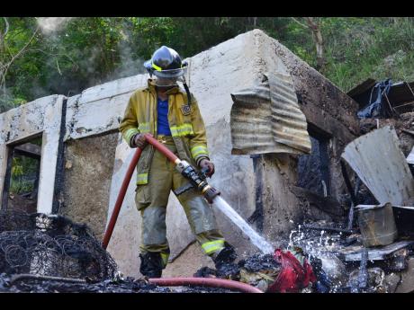 Fire ravaged this two-bedroom house in Burnside Valley, Red Hills, St Andrew, yesterday.