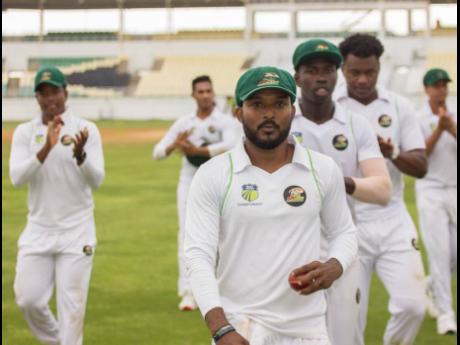 Man of the match Veerasammy Permaul is applauded off the field by his teammates after picking up eight wickets against the Jamaica Scorpions on day three of their Cricket West Indies Regional Four-Day Championship match at the Trelawny Stadium on Sunday, December 1, 2019.