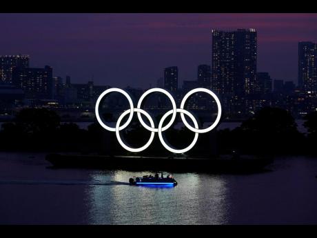 The Olympic rings float in the water at sunset in the Odaiba section of Tokyo, Japan, on Wednesday.