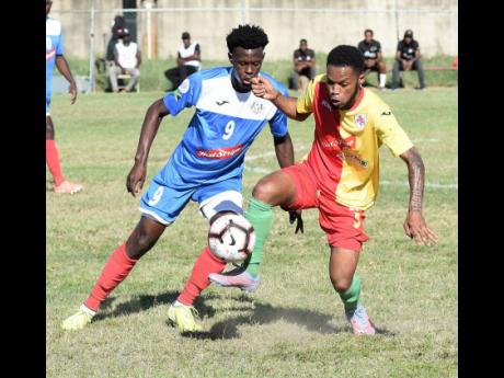 Humble Lion’s Courtney Hill (right) tries to move the ball away from Portmore United’s Chavany Willis during a Red Stripe Premier League game at the Spanish Town Prison Oval in St Catherine on Sunday, January 5.