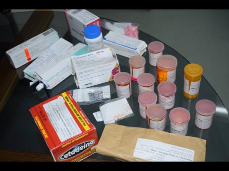 Evans shows the various medications that her daughter Shyan was taking.