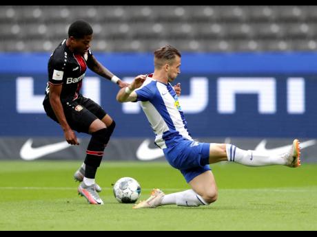 Credit: AP Bayer Leverkusen’s Leon Bailey (left) challenges Hertha Berlin’s Peter Pekarik for the ball during a German Bundesliga match in Berlin, Germany, on Saturday.