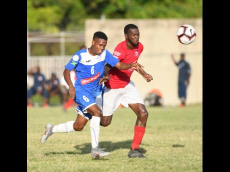 Portmore’s Lamar Walker (left) in a foot race with Dunbeholden’s Graeme Green during their Red Stripe Premier League encounter at the Spanish Town Prison Oval on Sunday, December 1, 2019.