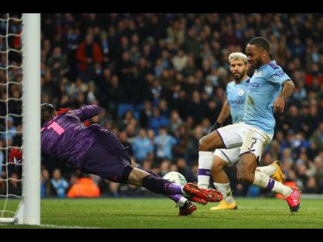Manchester City's Raheem Sterling (right) scores a goal disallowed for offside during the English League Cup semi-final second-leg match between Manchester City and Manchester United at Etihad stadium in Manchester, England, on Wednesday, January 29, 2020. 