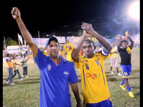Donovan Hayles (left) and Richard Edwards wave to to the crowd after Harbour View after winning the Premier League in 2007.